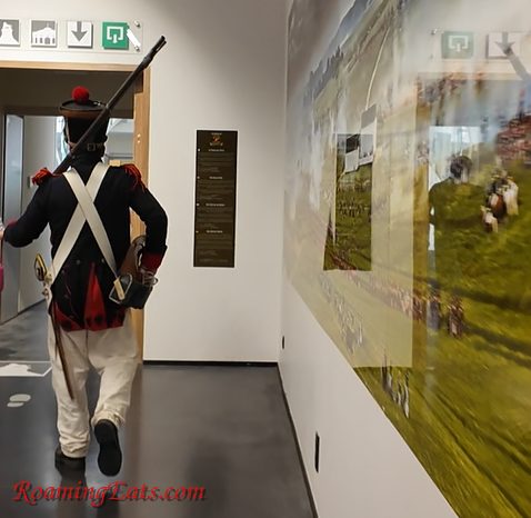 A guide in French military dress leading the Waterloo tour